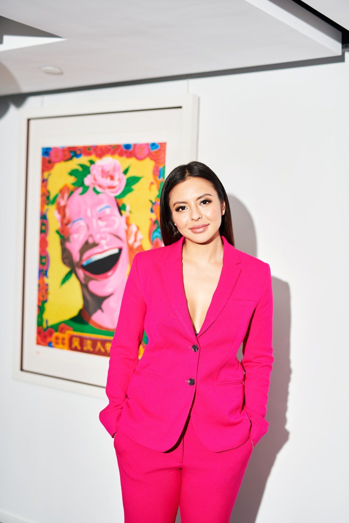 Sharlane Foo wearing a pink suit in a contemporary art gallery